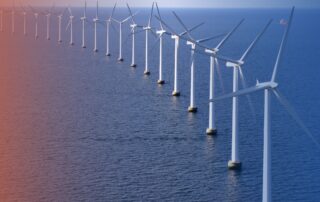 wind tubrines at sea on orange and blue background