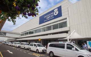 Exterior of Glasgow Airport terminal with taxis lined up outside, representing Stream Marine Training’s convenient location for maritime trainees.
