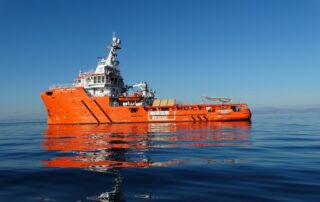 Offshore emergency response and rescue vessel (ERRV) at sea, supporting survival craft operations and Coxswain-led rescue and recovery training scenarios