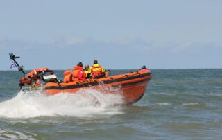 Fast rescue boat crew conducting high-speed rescue operations during offshore emergency response training
