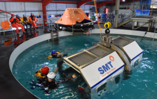 Delegates completing CA-EBS training during OPITO BOSIET helicopter underwater escape training in SMT pool facility Glasgow